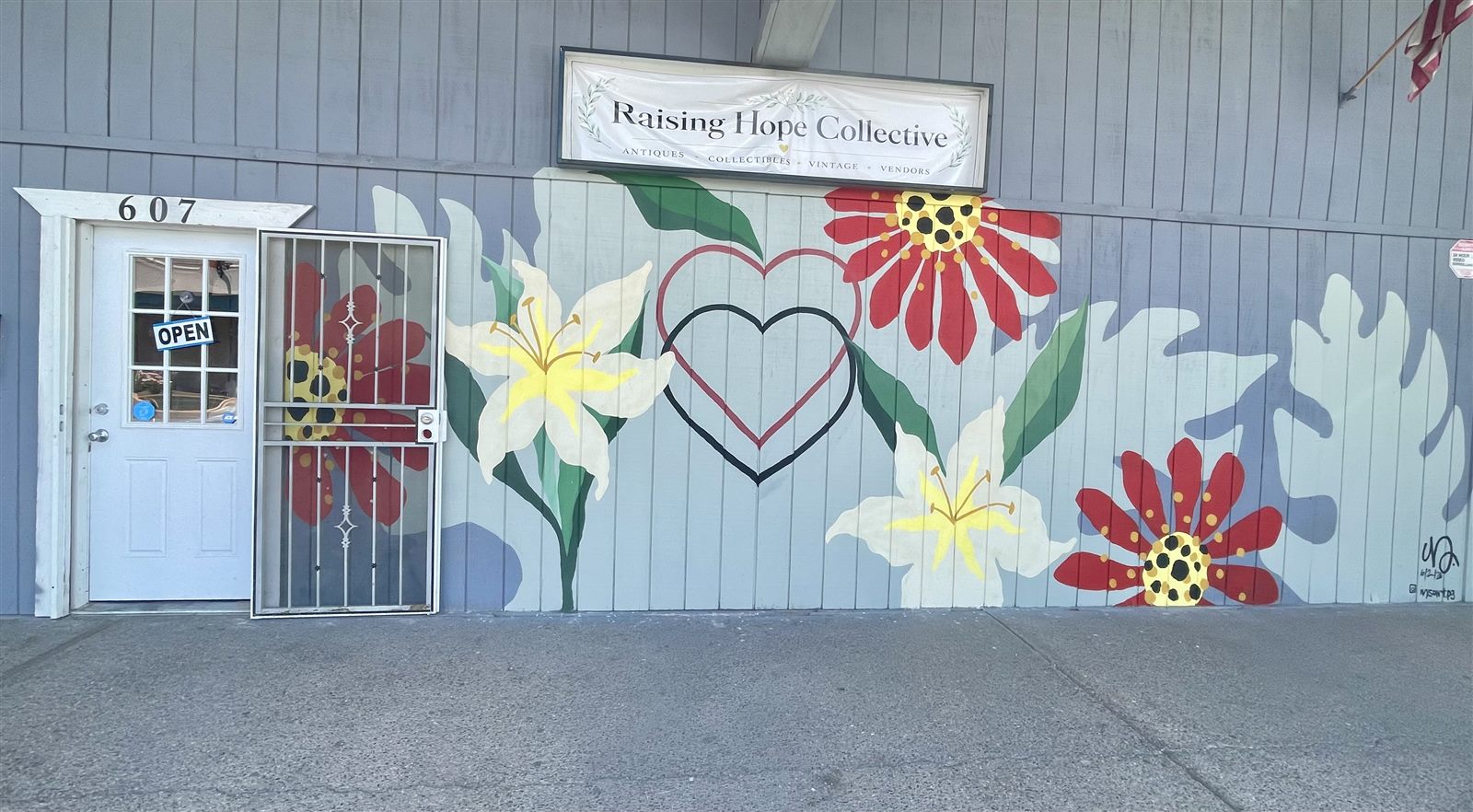 The Raising Hope Collective floral mural and entrance at 607 West Main Street