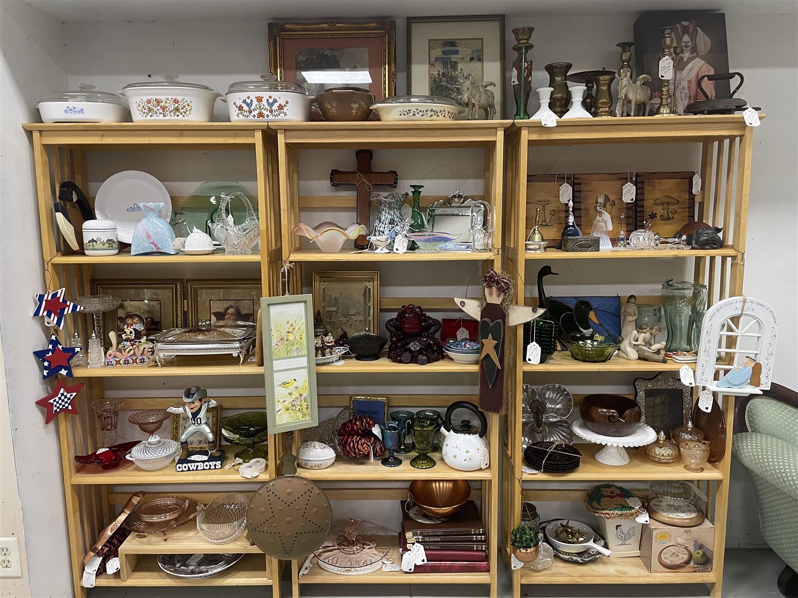 Shelves filled with vintage glassware, art, ceramics and home decor
