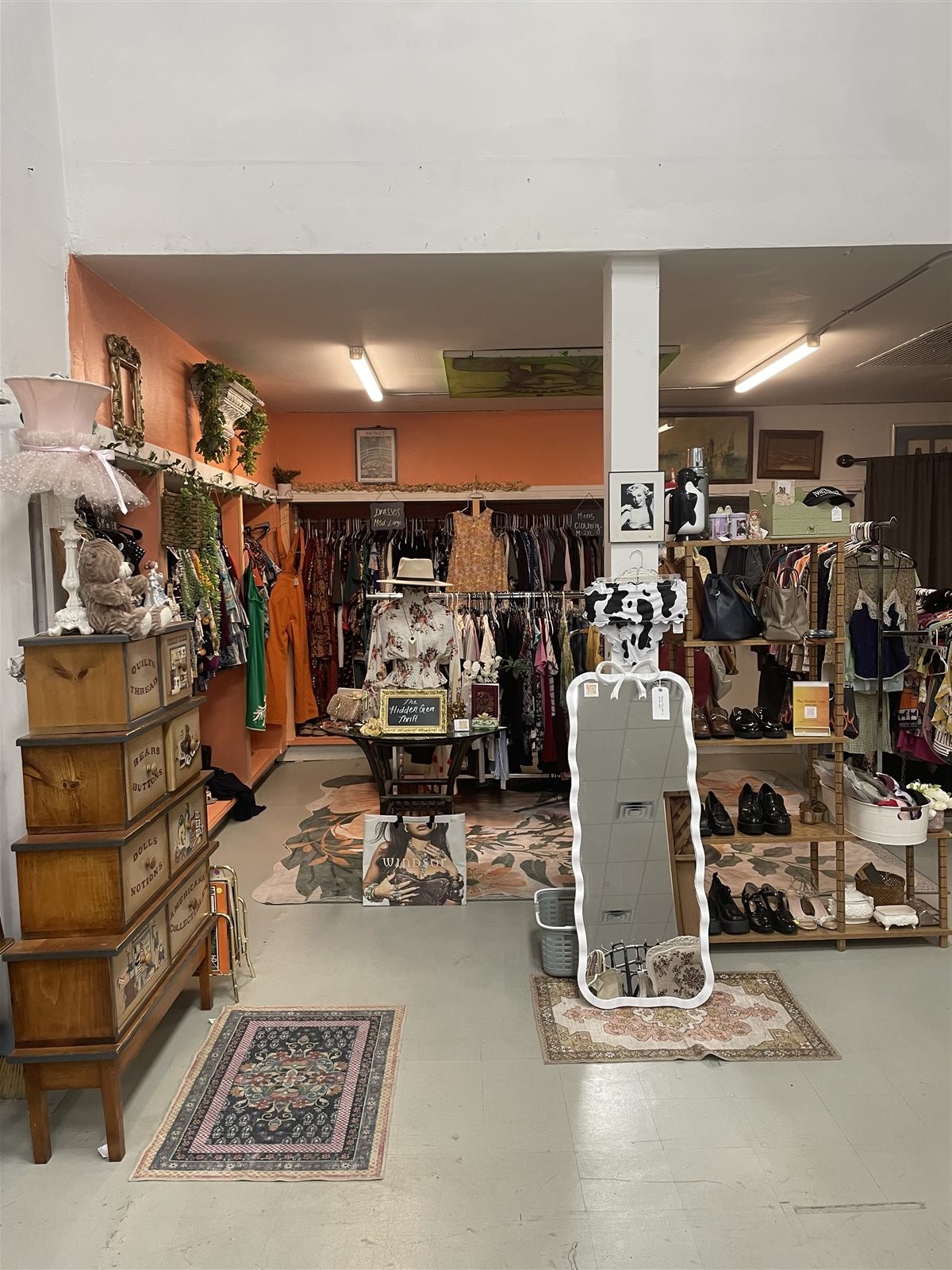 A colorful curated vintage clothing area inside Raising Hope Collective
