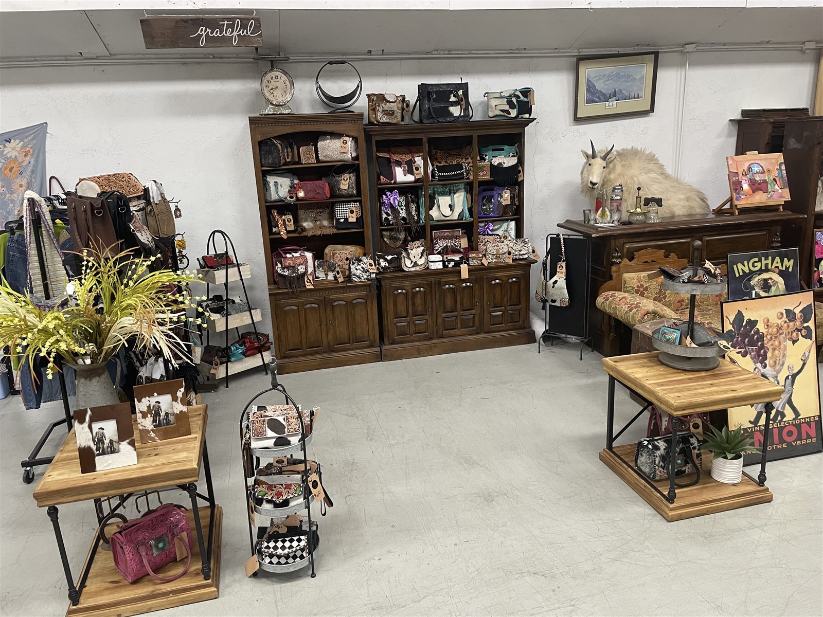 A vendor space filled with handbags, western accessories, art and antiques