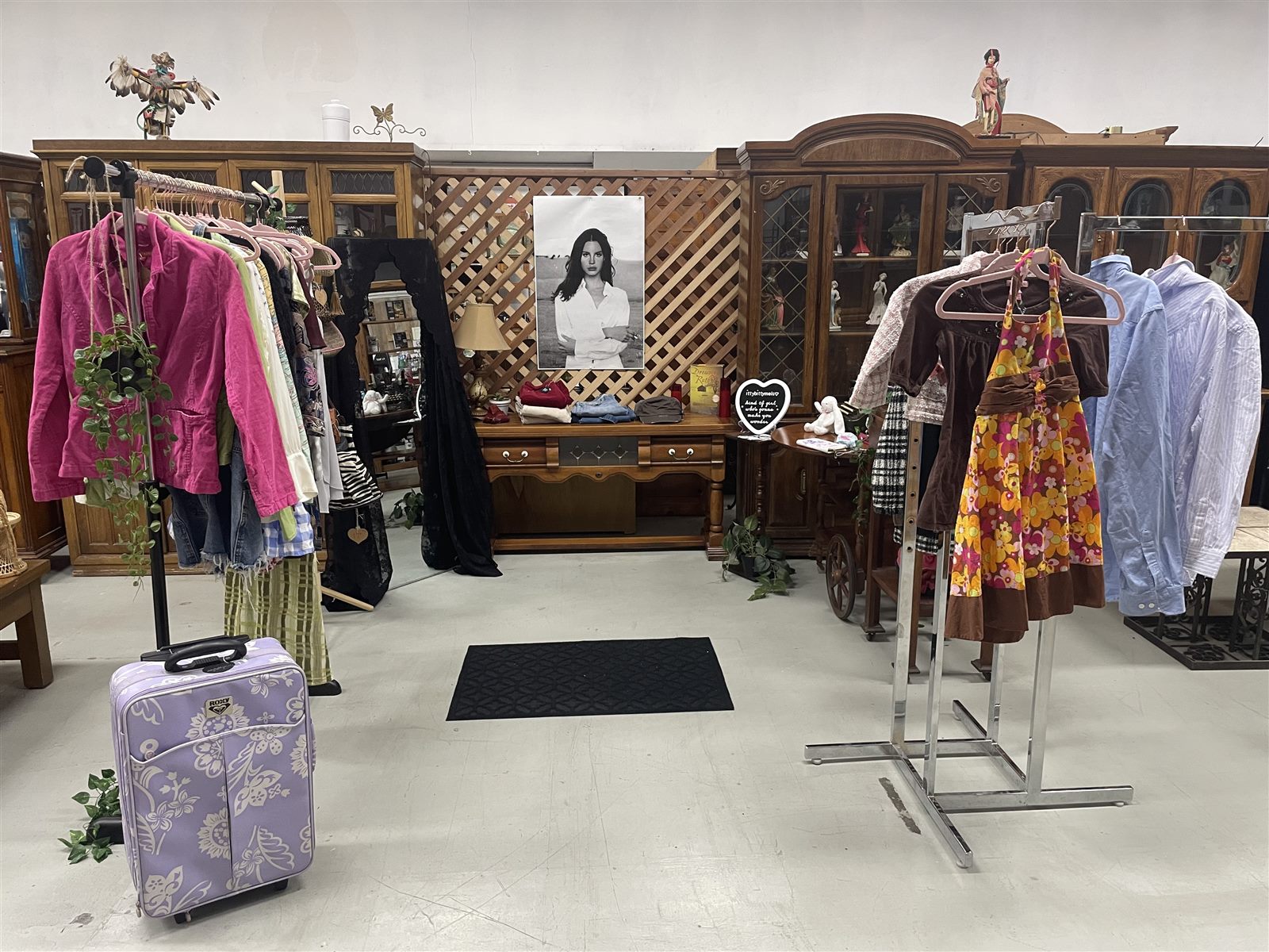 Y2K and retro clothing displayed among antique furniture